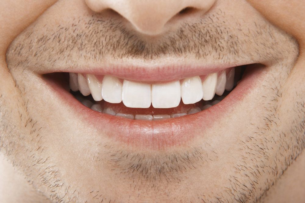 Close up of man's smile and stubble